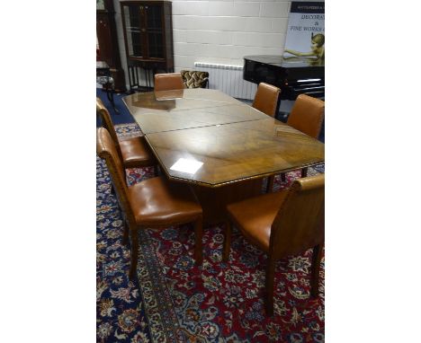 A RETRO WALNUT DINING ROOM SUITE, comprising extending draw leaf table with one extra leaf, six brown vinyl upholstered chair