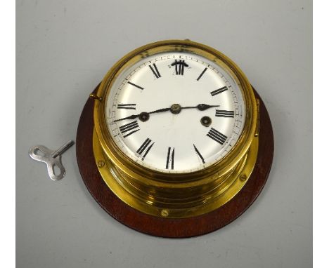 A BRASS CASED SHIPS BRIDGE CLOCK, enamel dial, twin barrel movement,  Seth Thomas, America, circa 1920 on plinth, max 29cm hi