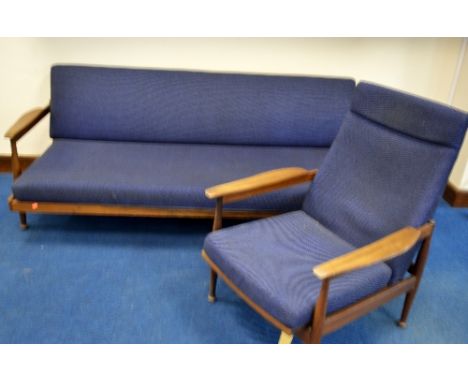 A 1970'S TWO PIECE SUITE, with teak frame and blue upholstery, comprising three seater sofa with swivel storage back rest and