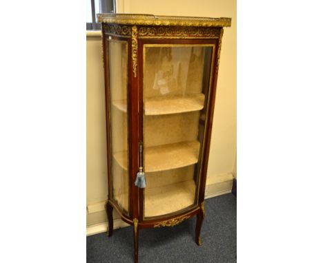 A FRENCH LOUIS XV STYLE WALNUT VITRINE, the serpentine front with ormolu beading and scroll mounts top, on four cabriole legs