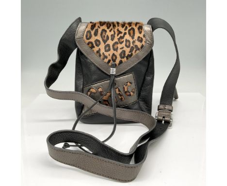 Mixed black, bronze and animal print bag with thick adjustable strap. Purse has pouch on front and back with snap button clos