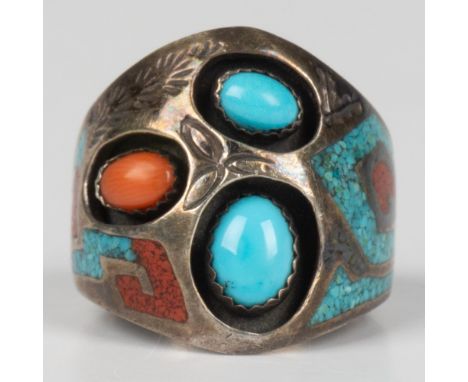 This finely crafted ring is sterling silver set with coral and turquoise stones. There is an elaborate turquoise and coral ch