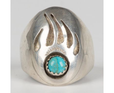 Beautifully crafted sterling silver ring featuring a bear paw with a round turquoise cabochon. Marked sterling on the inside.
