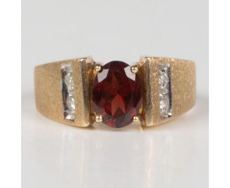 This beautiful ring has a 10k yellow gold band set with an oval garnet center stone and small diamond accents. Marked 10k ins