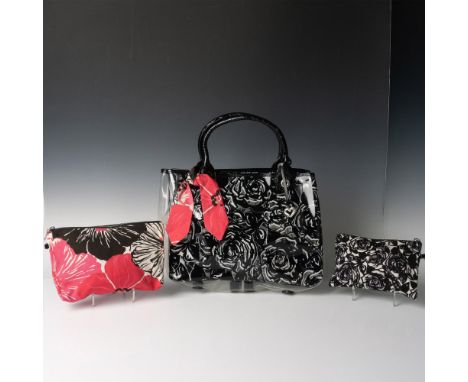 Black leather straps on a clear plastic decorated with black and white roses. Pink bow tied to strap. Brighton leather patch 