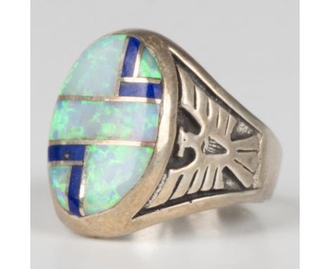 This fabulous ring is sterling silver with carved thunderbirds and inlaid opal and lapis lazuli stones. Marked sterling silve
