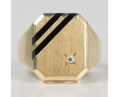 This contemporary ring is made from 14k yellow gold set with a diamond and two onyx stripes. Marked 14kt Holland inside the b