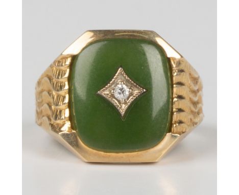 This gorgeous ring has an engraved 24k yellow gold band with a small diamond set inside the center jade stone. It is marked 2