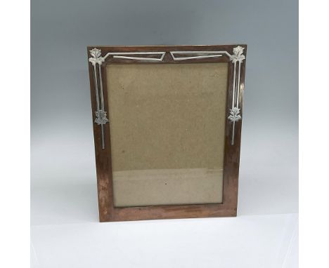 Bronze photo frame with applied silver leaf border to the top half. Smaco backstamp. Issued: c. 1920Dimensions: 10.75"L x 8.7