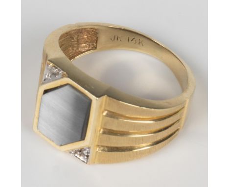 This beautiful ring has a grey cat's eye stone with a diamond on either side set in a 14k gold band marked on the inside. Siz