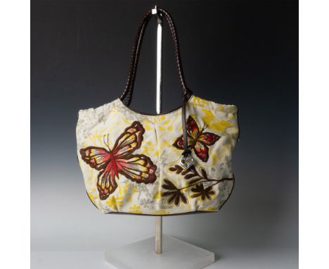 Beige, yellow, and grey canvas handbag with brown stitched butterflies. Brown leather handles and bottom. Magnetic button clo