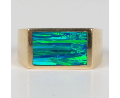 This bold ring has a 14k yellow gold band inlaid with a large rectangular opal. Inside of the band is marked 14k. Size 9.5, 8