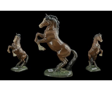 Beswick Rearing Brown Horse Figure, 11'' high, marked Beswick and JM to base.  A Beswick pottery figurine, depicting a rearin