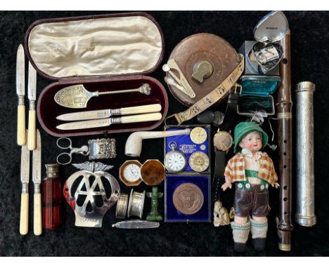 An Assortment of Collectables to include a vintage clarinet, an old doll,a vintage tape measure, odd silver, AA badge, soapst