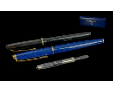 Two Waterman Pens with one original box. One in mottle blue design with gold tone nib and One with 14 carat gold nib. Champio