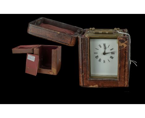 A Brass Carriage Clock, typical form, white dial, Arabic numerals, with case and further empty case.