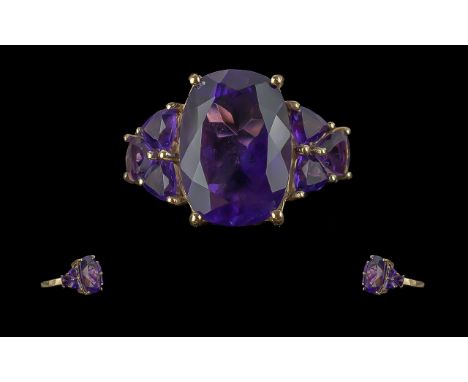 Ladies 18ct Gold Attractive Amethyst Set Dress Ring. Marked 9ct to Interior of Shank. The Large Central Faceted Amethyst Set 