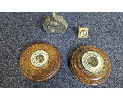 Four Barometers, comprising two round wooden framed, one set in slate by Yewdale Lakeland Stone of Coniston, and a small marb