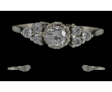 18ct White Gold Pleasing Diamond Set Ring. Full Hallmark to Interior of Shank. The Central Round Faceted Diamond Flanked by S