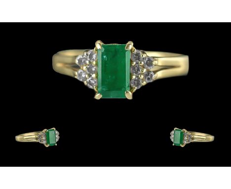 Ladies 14ct Gold Attractive 14ct Gold Emerald and Diamond Set Ring. Marked 14ct to Interior of Shank. The Step cut Emerald of