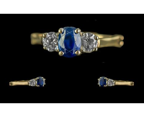 14ct Gold Three Stone Ring, Central Sapphire set between two brilliant cut diamonds, est. total diamond weight .70 cts.  Adju