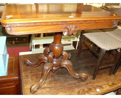 A mid-Victorian mahogany and flame mahogany round cornered baize lined fold-over card table, having swivel top and raised on 