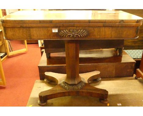 An early Victorian rosewood round cornered fold-over baize lined card table, having a swivel top and raised on an octagonal c