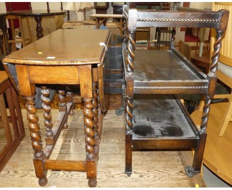 A 1920s barley twist oak gateleg occasional table, together with a further 1920s barley twist oak three-tier tea trolley on r