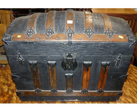 A black painted canvas, wood and iron bound domed hinge top travelling trunk, width 78cm