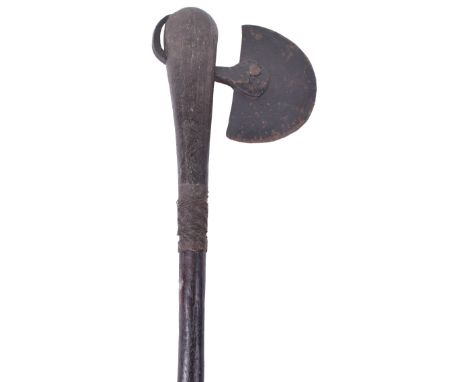 19th Century Zulu Axe (Isizenze), having a steel half moon blade, dark hardwood haft with swollen top and centre with remains