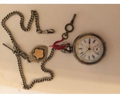 A 19th century lady's French enamel pocket watch with silver chain and fob medal and key, plus a silver pocket watch with key