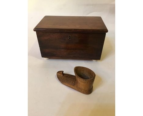 A wooden jewellery box with ceramic bun feet and wooden shoe.