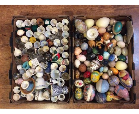A collection of assorted hand decorated and transfer printed eggs, in ceramic, papier mache, enamel, wood, stone, glass and p