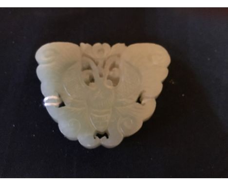 A Chinese carved jade pendant, reticulated form, modelled as a moth, approx 6.5cm wide