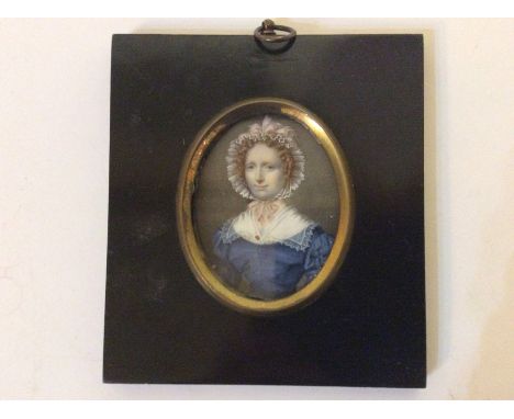 A Regency oval portrait miniature on ivory of a young woman, signed and dated 1825, framed