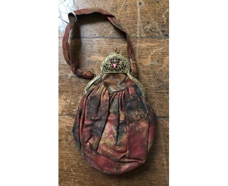 A marble printed floral leather purse with a matching leather handle, a brass fretwork frame and a ruby style detail