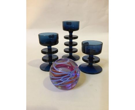 Three Sheringham blue glass candlesticks (various sizes-  tallest 15cm high approx.) and a Caithness paper weight.Condition: 