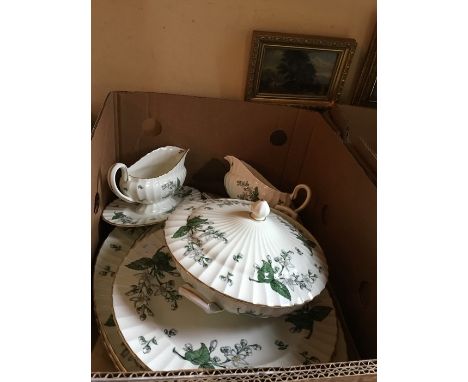 A Royal Worcester dinner service including covered vegetable tureen, platters and gravy boats/stands in Valencia pattern, (2 