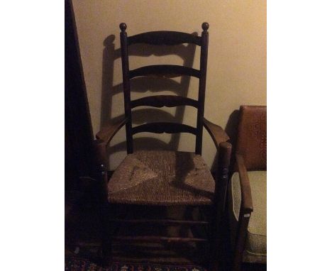 A late 19th Century ash ladder back armchair with rush seat, fitted with four rails to back, straight turned front supports, 