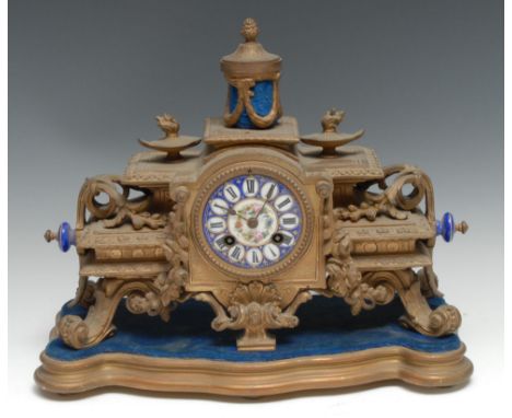A 19th century French porcelain mounted gilt metal mantel clock, 8cm diam inscibed with Roman numerals and painted with flowe
