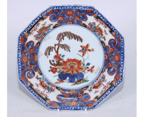 A Chinese hexagonal plate, the field painted with a lily and other foliage, scroll and flowerhead border, 21.5cm diam, c.1790