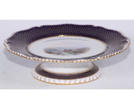 A Royal Worcester circular comport,  painted  by Harry Davis with a Loch scene, the rim with partridge eye in gilt on a cobal
