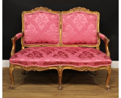 A 19th century giltwood and gesso sofa, stuffed-over upholstery, carved and applied throughout with flowers and leaves, Frenc