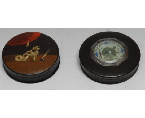 A 19th century papier-mâché circular snuff box, the push-cover painted with a dog by a inkwell and a feather pen, 7.5cm diam;