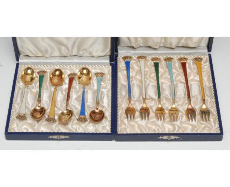 A set of six Danish silver-gilt and enamel coffee spoons, crown terminals, cased; a set of six pickle forks, to match, cased 