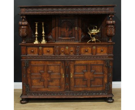 A 17th century design oak duodarn, rectangular top above a panel door, two short drawers and a pair of further panel doors, a