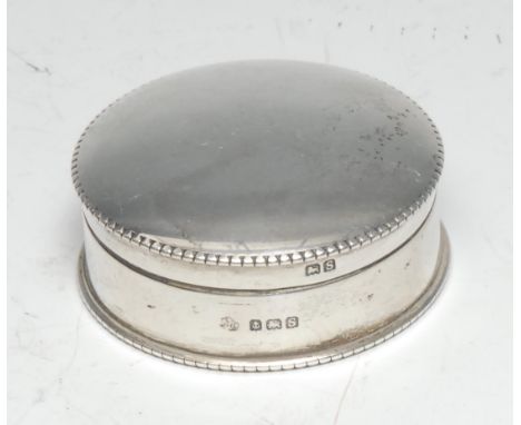 A George V silver circular rouge box, quite plain, domed cover with milled border, enclosing a card box, Poudre Nilde, Paris,