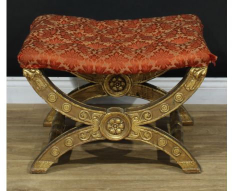 A large Baroque design giltwood X-frame stool, stuffed over deep-button seat, the underframe carved and gessoed with flowerhe