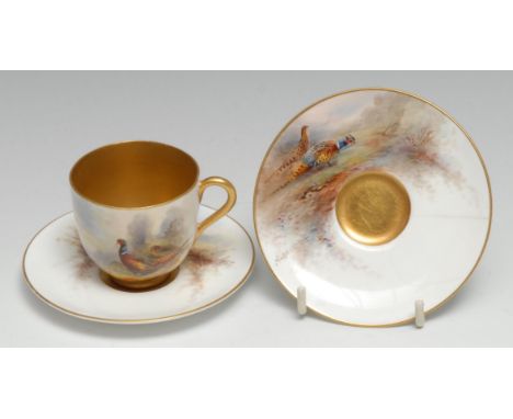 A Royal Worcester cabinet cup and saucer, painted by Jas Stinton, signed, with pheasant, gilt interior, printed crown and cir