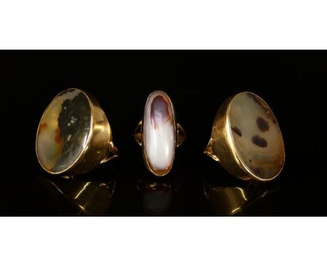 An oval moss agate and 9ct gold ring, set in a deep plain collar, shank divided at the shoulder, size Z, 8.4g gross; another 